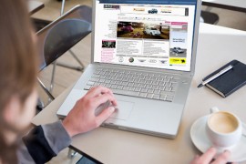 Young Man Using Laptop in Cafe --- Image by © Stefanie Grewel/zefa/Corbis